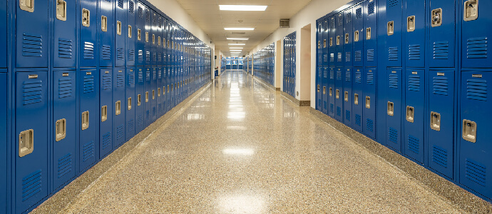 empty school hallway with royal blue metal lockers