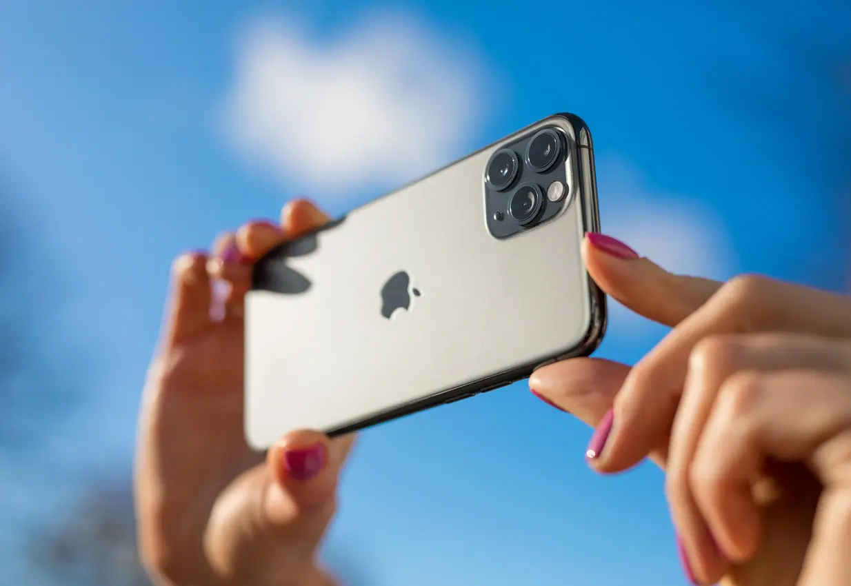 woman shooting a video on her iPhone